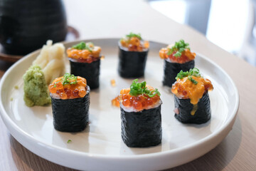 Salmon eggs or Ikura in Japanese style sushi fresh from raw salmond fish in the restaurant.