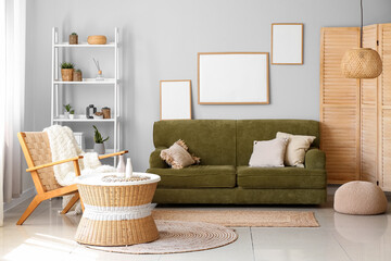 Interior of cozy living room with rattan table and green sofa
