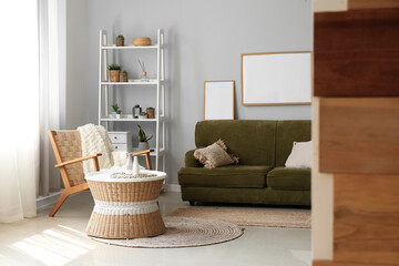 Interior of cozy living room with rattan table and green sofa