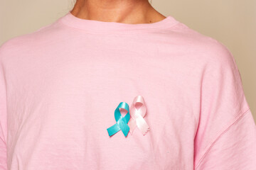 Woman promoting breast cancer awareness with pink and blue ribbon for men and women