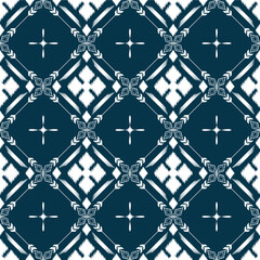 Naklejka premium Ikat ethnic background vector. Seamless pattern of white geometric shapes with star and flower on dark blue background.