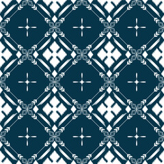 Ikat ethnic background vector. Seamless pattern of white geometric shapes with star and flower on dark blue background.