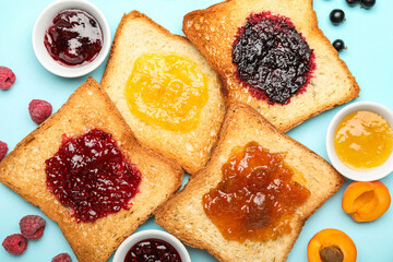 Composition with toasts and jams on color background, closeup