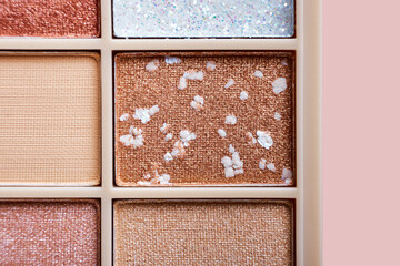 Fototapeta premium Eyeshadow colorful shades palette in beige tones close-up. Beauty abstract background