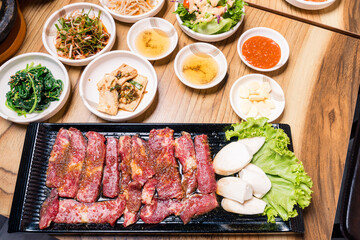 Korean BBQ set. Beef for grill on stove serve with vegetable and soup wood table , Japanese food style barbecue