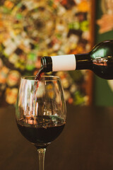 waitress serving glass of wine in restaurant at night