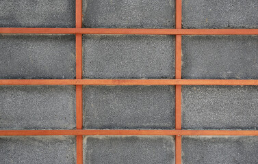 Gray block wall with wood square grid japanese style as background.