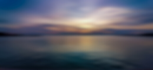 Fototapeta na wymiar Abstract background of evening sky and sea, blurry pattern. Water pattern at sunset and blur. Lake, clouds, yellow light from the twilight sun.