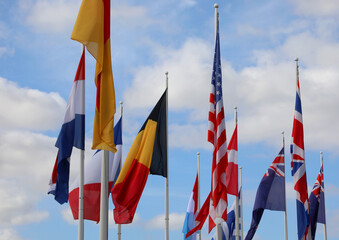 international flags like Belgium United States England Australia waving with the sky background