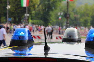 blue flashing of the siren of the police car during the demonstration for the surveillance
