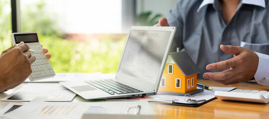 Real estate business concept A rental company employee is calculating the cost for the customer to...