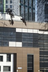 Full-color vertical photo. The geometric composition is made up of sections of the facades of city buildings.