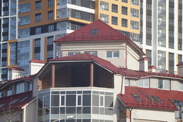 Full-color horizontal photo. Urban landscape. Part of the facade of a building under construction. Geometric linear composition with windows.