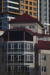 Full-color vertical photo. The geometric composition is made up of sections of the facades of city buildings.