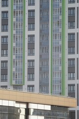 Full-color vertical photo. The geometric composition is made up of sections of the facades of city buildings.