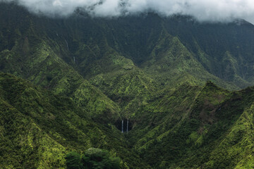 A secluded waterfall in the lush valleys of Kauai
