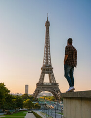 Young men watching sunrise by the Eiffel tower, Eiffel tower at Sunrise in Paris France, Paris...