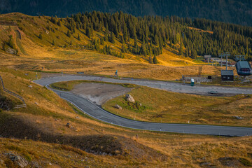 Beautiful sunrise on the Jaufenpass or Passo Giovo in northern italy with beautiful road winding on...