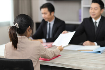 Human resources department managers sitting and interviewing female businesswoman applicant or...