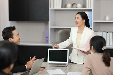 Collaborative process of professional businesspeople going over on new project together, using computer presentation and brainstorming ideas, coworker and working together at office meeting concept