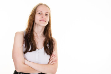 Young confident and determined girl cross arms chest in self-assured pose smiling pleased stand white background