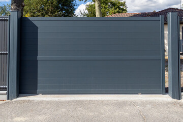 high dark grey home door aluminum gate gray slats portal garden of suburb house