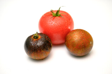 Czarne pomidory. Czerwony i czarny pomidor z kroplami wody na skórce. Dojrzałe warzywa. Warzywa do sałatki. Zdrowa dieta. Dieta warzywna.  - obrazy, fototapety, plakaty