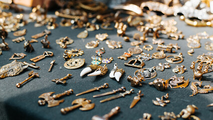 Bronze jewelry, medieval amulets and handmade souvenirs sold outdoors. Selective focus, close-up