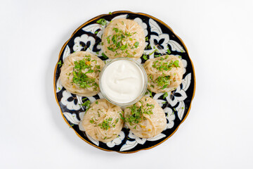 Large khinkali with lamb on a plate top view