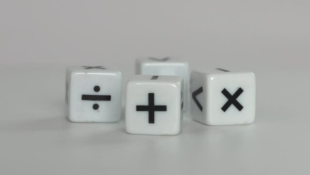 Four&nbsp;white&nbsp;dice&nbsp;with&nbsp;mathematical&nbsp;math&nbsp;symbols. Business concept with miniature.
