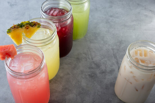 A View Of A Row Of Various Agua Fresca Beverages.