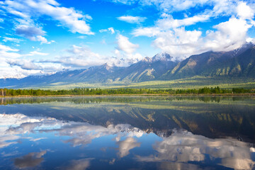 Landscape with mountains reflecting in the water on summer sunny day. Buryatia, Tunkinskaya valley