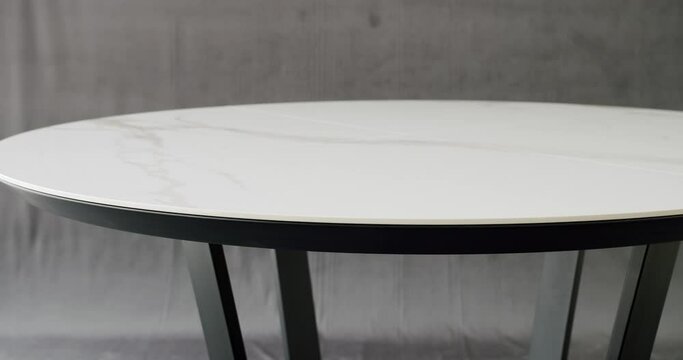 Elegant and Comfortable Home at Dining room. Modern Dining Room Interior with minimalist round table. Minimalist White Dining Round Table on isolated grey background. Modern stylish White Table.