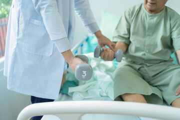 Old elderly patient or pensioner and a doctor smiling, doing exercise, working out  in nursing home in hospital. Senior people lifestyle activity recreation. Health care physical therapy.