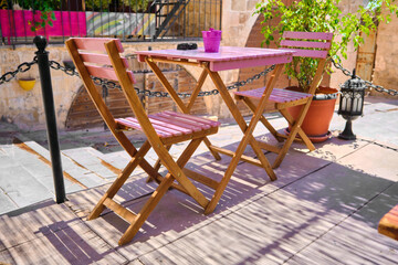 cute cafe and outdoor cafe table.purple color chairs wooden made.