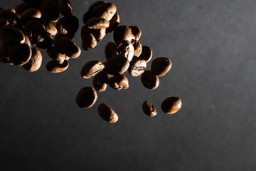 heap of coffee beans on black background