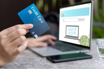 Woman using smart phone and credit card for shopping online in coffee shop cafe