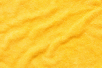 Surface of yellow microfiber cloth, macro textile pattern background