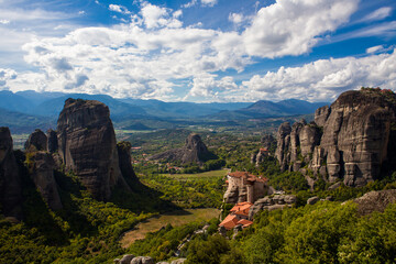 Cliff side view of Meteora in a Beautifully Cloud Speckled Sky