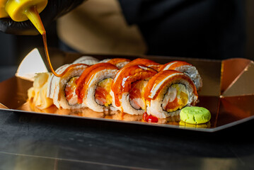 chef decorating sushi rolls