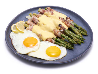 Healthy food - Asparagus wrapped with bacon and spices on a plate isolated on white background