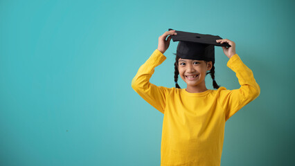 Photo of lovely small girl touch cap wear eyewear striped blazer isolated on pastel green color background