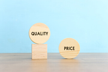 A hand chooses a cube with the word quality, versus price