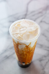 A view of a brown sugar syrup boba milk tea beverage.