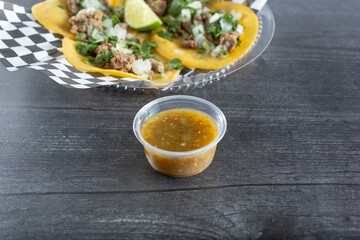 A view of a condiment cup of salsa.