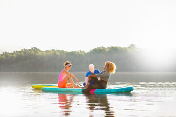 Three friends enjoying their day and relaxing on SUP boards