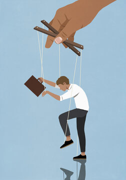 Hand controlling businessman on puppet strings
