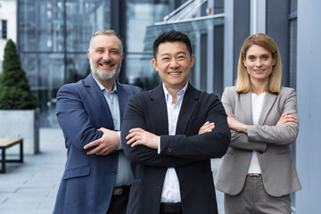 Successful diverse business team, three workers smiling and looking at camera, dream team with...