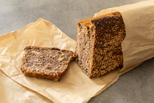 Still life sliced rustic rye bread loaf in parchment paper
