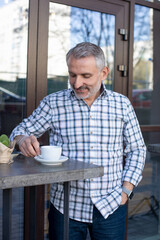 Street cafe visitor enjoying his coffee break